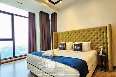 a bedroom with a large bed with a large window at Expressionz Premium Suites @ KLCC in Kuala Lumpur
