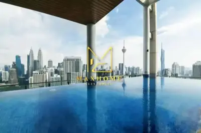a swimming pool on the roof of a building with a city skyline at Maxhome at The Luxe By Infinitum in Kuala Lumpur