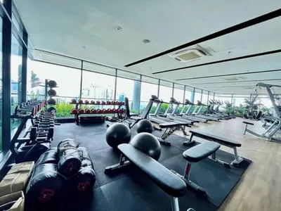 a gym with a lot of treadms and machines at Maxhome at The Luxe By Infinitum in Kuala Lumpur