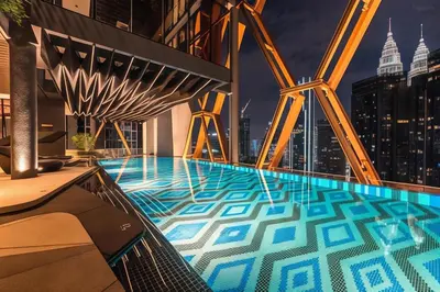 a swimming pool on top of a building with a city skyline at Scarletz Suites KLCC by M Suites in Kuala Lumpur