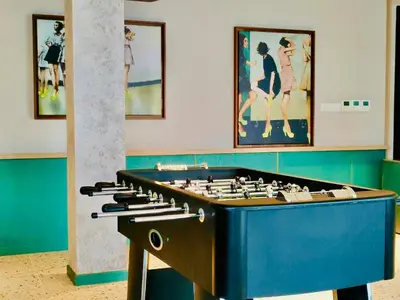 a large chess board in a room with paintings at Scarletz Suites KLCC by M Suites in Kuala Lumpur