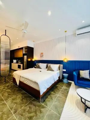 a bedroom with a large bed and a blue wall at Scarletz Suites KLCC by M Suites in Kuala Lumpur
