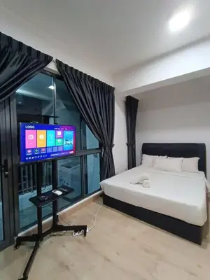 a bedroom with a bed and a flat screen tv at CLS 16B KLCC Balcony View Studio in Kuala Lumpur