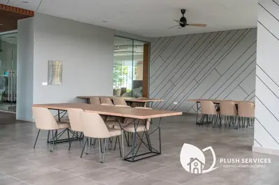 a dining room with a wooden table and chairs at Sentral Suites by Plush in Kuala Lumpur