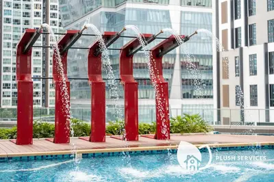a pool with a water slide in a city at Sentral Suites by Plush in Kuala Lumpur