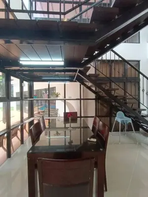 a dining room with a glass table and chairs at Titiwangsa9 Bungalow Pool Villa in Kuala Lumpur