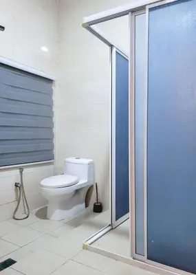 a bathroom with a toilet and a glass shower at Titiwangsa9 Bungalow Pool Villa in Kuala Lumpur