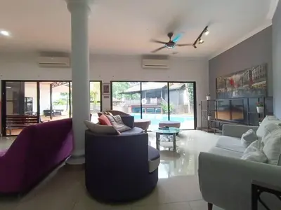 a living room with couches and a ceiling fan at Titiwangsa9 Bungalow Pool Villa in Kuala Lumpur