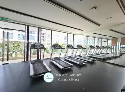a row of treadmills in a gym with windows at The Robertson Bukit Bintang Kuala Lumpur by Cloud Host in Kuala Lumpur