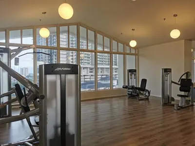 a gym with treadmills and machines in a large room at Una Serviced Apartment, Jalan Peel by Rverse Suite in Kuala Lumpur