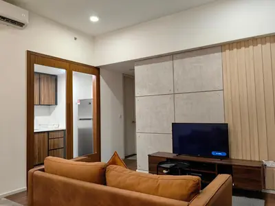 a living room with a couch and a tv at Una Serviced Apartment, Jalan Peel by Rverse Suite in Kuala Lumpur