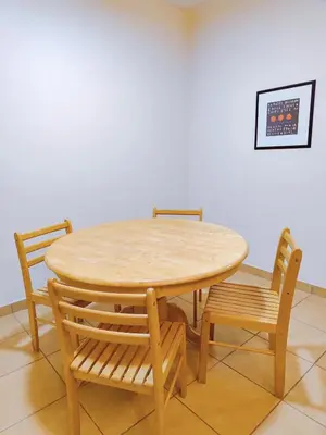 a wooden table and chairs in a room at Fahrenheit Pavillion Bukit Bintang By JS-Home in Kuala Lumpur