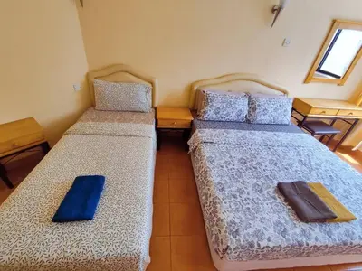 two beds in a small room with blue sheets at Fahrenheit Pavillion Bukit Bintang By JS-Home in Kuala Lumpur