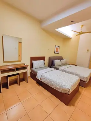a room with two beds and a table and a mirror at Fahrenheit Pavillion Bukit Bintang By JS-Home in Kuala Lumpur