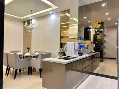a kitchen and dining room with a counter and chairs at Dorsett Residence Bukit Bintang 3MinsTo Pavilion By HeyStay Management in Kuala Lumpur