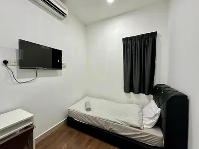 a small room with a bed and a flat screen tv at Hotel Arba in Kuala Lumpur