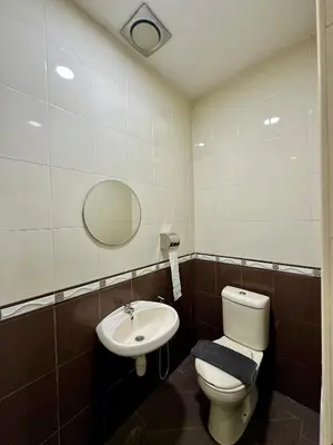 a bathroom with a toilet and a sink at Hotel Arba in Kuala Lumpur