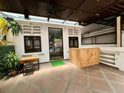 a patio with a wooden table and a table and chairs at Hotel Arba in Kuala Lumpur