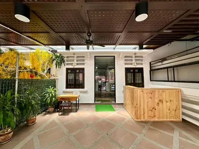 a patio with a table and chairs and a building at Hotel Arba in Kuala Lumpur
