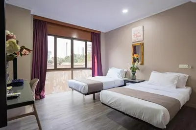 a hotel room with two beds and a window at HOTEL 28 RAPID in Kuala Lumpur