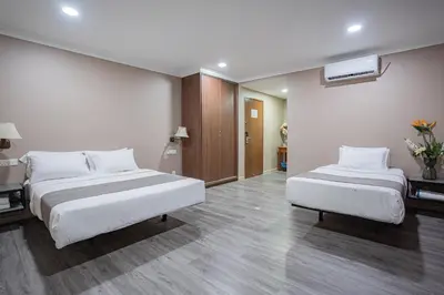 a hotel room with two beds and a hallway at HOTEL 28 RAPID in Kuala Lumpur