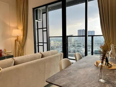 a living room with a table and a large window at KLCity & KLCC View Modern Style 2R2B - 6 pax in Kuala Lumpur