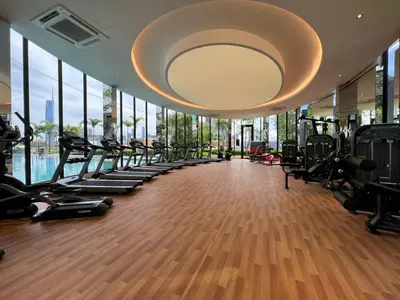 a gym with a row of treadmills and ellipticals at KL City View 2R1B Free Wifi 6pax in Kuala Lumpur