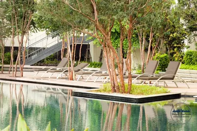 a group of chairs sitting next to a pool of water at Lucentia Residence by EAS Maju property in Kuala Lumpur