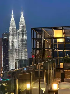a view of the petronas twin towers at night at Luxurious Condo in Heart of Kuala Lumpur with Rooftop Garden in Kuala Lumpur