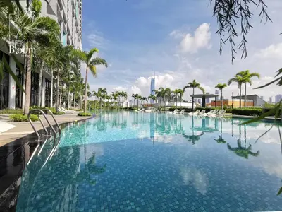 a large swimming pool with palm trees and a building at Trion KL High floor Corner Unit Free Parking Near TRX KL Centre and MRT in Kuala Lumpur
