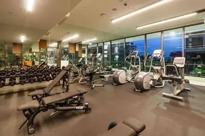 a gym with a lot of treadmills and machines at The Robertson Residence KL Bukit Bintang Chinatown Jalan Alor by \u54c1\u5c4b PINWU Shortstay in Kuala Lumpur