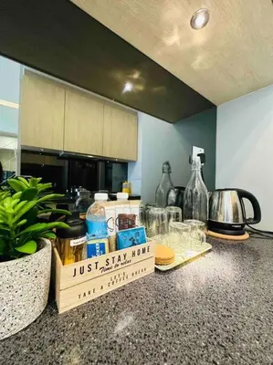 a kitchen counter with some items on top of it at The Robertson Residence KL Bukit Bintang Chinatown Jalan Alor by \u54c1\u5c4b PINWU Shortstay in Kuala Lumpur