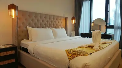 a hotel room with a large bed and a window at Lalaport Suites At Lucentia Bukit Bintang City Center in Kuala Lumpur