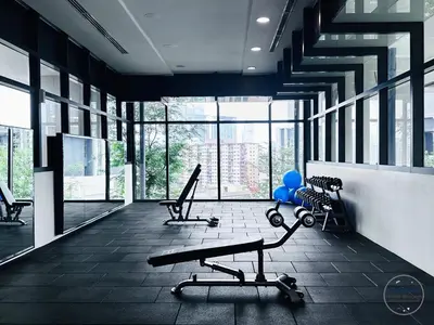 a gym with two chairs and a bench and windows at LUCENTIA RESIDENCE BY HOME HORIZON in Kuala Lumpur