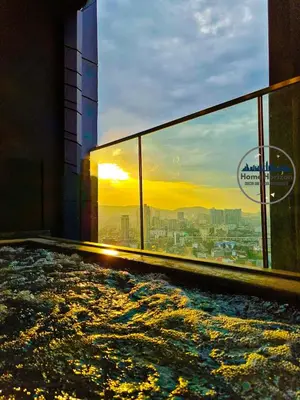 a building with a view of the sunset from a swimming pool at LUCENTIA RESIDENCE BY HOME HORIZON in Kuala Lumpur