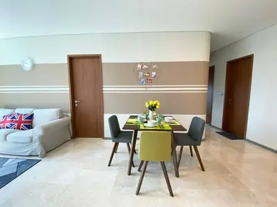 a dining room with a table and chairs and a couch at Sky Suite @ KLCC - 3BR KLCC View in Kuala Lumpur