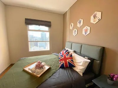 a bedroom with a bed with a tray with a flag at Sky Suite @ KLCC - 3BR KLCC View in Kuala Lumpur