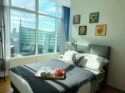 a bedroom with a bed with a tray on it at Sky Suite @ KLCC - 3BR KLCC View in Kuala Lumpur