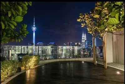 a view of the kuala lumpur skyline at night at 1 Room 1 Bathroom The Robertson KLCC in Kuala Lumpur