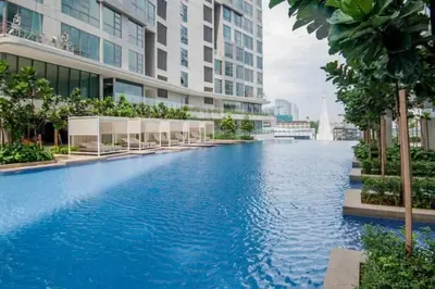 a large swimming pool in the middle of a building at 1 Room 1 Bathroom The Robertson KLCC in Kuala Lumpur