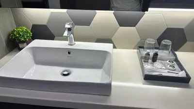 a white sink with a faucet on a counter at Ceylonz Suites Bukit Bintang by KL ONE in Kuala Lumpur