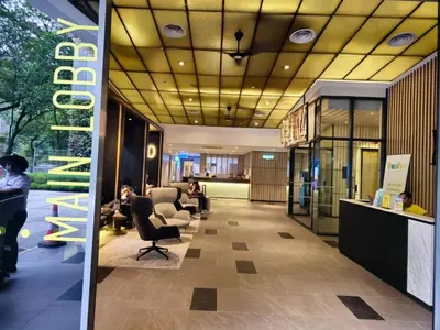 a lobby with people sitting in chairs in a building at Ceylonz Suites Bukit Bintang by KL ONE in Kuala Lumpur