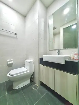 a bathroom with a toilet and a sink and a mirror at Q Suite @ Queensville Kuala Lumpur by Moka in Kuala Lumpur