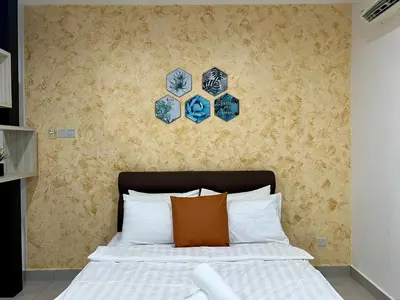 a bedroom with a bed with blue and white pillows at Q Suite @ Queensville Kuala Lumpur by Moka in Kuala Lumpur