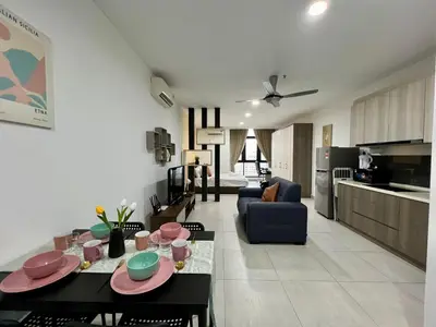 a living room with a dining table and a kitchen at Q Suite @ Queensville Kuala Lumpur by Moka in Kuala Lumpur