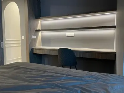 a bedroom with a bed and a blue chair at Eaton Residences KLCC by Romeo Bnb in Kuala Lumpur