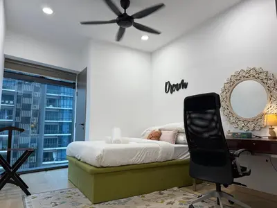 a bedroom with a bed and a desk and a ceiling fan at Eaton Residences KLCC by Romeo Bnb in Kuala Lumpur