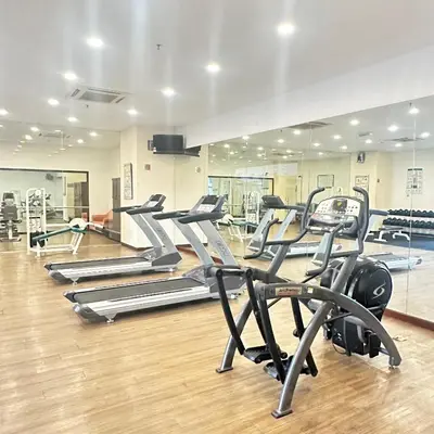 a gym with several tread machines in a row at Peak Suites At Times Square in Kuala Lumpur