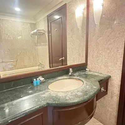 a bathroom with a sink and a mirror at Peak Suites At Times Square in Kuala Lumpur