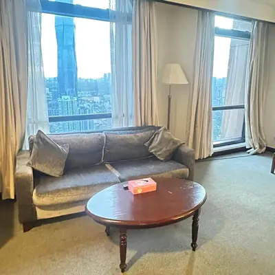 a living room with a couch and a coffee table at Peak Suites At Times Square in Kuala Lumpur